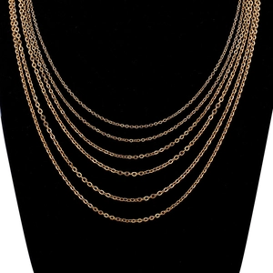 Layered punk gold chain necklaces on black mannequin showing multiple length options