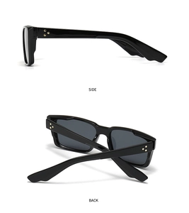 Detail view of black square sunglasses featuring side star rivets and polished frames