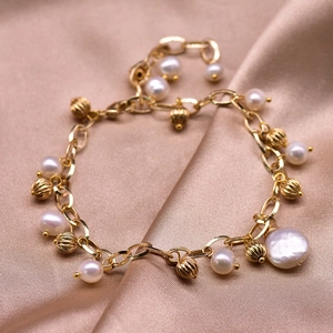 Golden baroque freshwater pearl bracelet featuring large pearl and textured metal beads