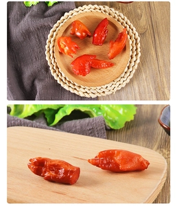 Macro shot of realistic food keychain showing glossy texture of fake chicken wings