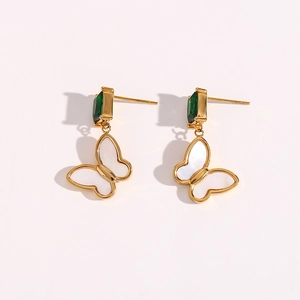 Close-up of gold stainless steel hoop earrings with green zircon and white shell butterfly