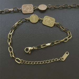 Gold stainless steel bracelet featuring lucky round tag and engraved angel square pendant