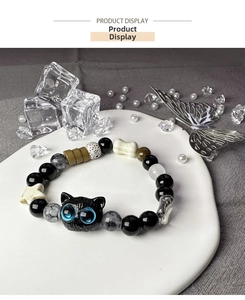 Macro view of 18mm black acrylic cat charm on a mixed bead punk style DIY bracelet