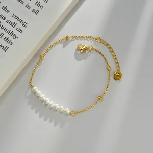 Elegant gold stainless steel bracelet featuring lustrous white pearls and golden beads