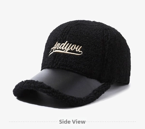 Close-up of black sherpa baseball cap featuring PU leather brim and gold Andyou embroidery