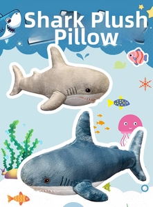 Detail of plush shark pillows in blue and grey with soft scales and sharp tooth details