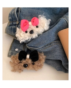 Detailed view of plush teddy dog hair clips in white and brown with cute bows
