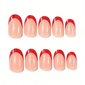 Close-up of glossy red French tip almond press-on nails with a nude pink base