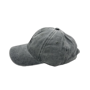 Detailed side view of washed cotton baseball cap featuring black embroidery on gray fabric