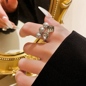 Detail of elegant open ring with grey pearls and sparkling cubic zirconia stones