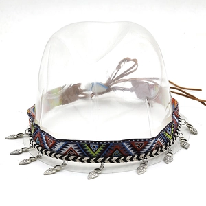 Detail of bohemian hat band with colorful geometric patterns and silver leaf charms