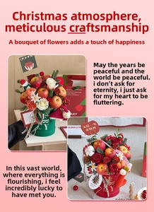 Detail of Christmas gift box with red roses, apples, and gold lettering on pink background