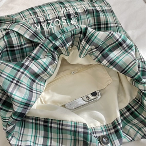 Detail view of large canvas tote interior showing zipped inner pocket and phone storage