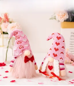Detail of pink Valentine's gnomes with knitted hats and plush beards on a floral background