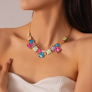 Detail of colorful geometric enamel square necklace with elegant gold chain on neck