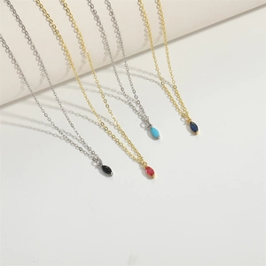 Minimalist gold and silver chains with colorful elliptical gem pendants in various hues