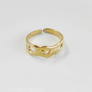 Close-up of golden irregular wavy hollow-out pattern on the stainless steel ring