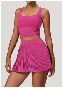 Detail of rose pink yoga vest with side ruching and matching pleated tennis skirt