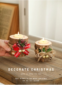 Detail of Christmas wooden candle holder with red berries and Merry Christmas ribbon