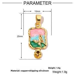Detail view of gold butterfly pendant with colorful enamel and 25mm x 10mm dimensions