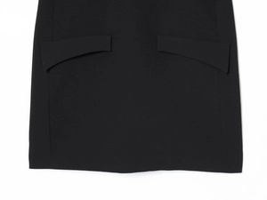 Detail of black mini dress featuring symmetrical curved flap pockets and woven texture