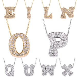 Sparkling zircon-encrusted gold and silver letter necklaces in a sleek cursive font style