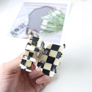Classic black and white checkered acetate hair claw clip with durable metal spring