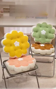 Detailed view of soft flower cushions in yellow, green, pink and brown corduroy fabric