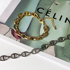 Detailed view of the 18k gold plated titanium steel link chain with stylish oval buckle