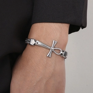Detail shot of a silver stainless steel braided bracelet with an Ankh cross pendant