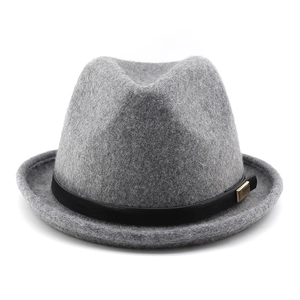 Detail of grey wool fedora hat featuring a black leather band and gold metal buckle accent