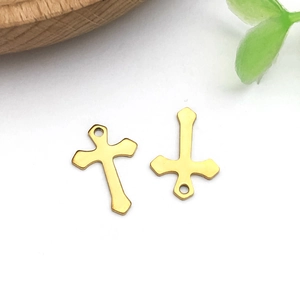 Detailed view of polished gold stainless steel cross pendants for DIY jewelry making