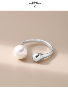 Close-up detail of S925 sterling silver open ring with white pearl and metal ball