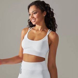 Detailed texture of seamless white knitted sports bra with ribbed supportive waistband
