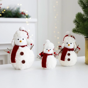 Detailed view of three plush Christmas snowmen in varying sizes with red scarves and hats