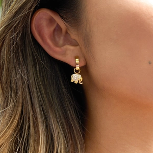Macro detail of elephant earring with sparkling crystals and gold finish on ear model