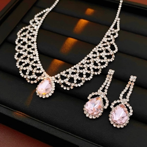 Silver jewelry set with pink pear-cut crystals and clear rhinestones on display