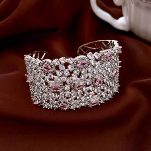 Detail of silver-plated cuff with pink pear-cut crystals and white zircon hollow lace