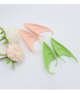 Cosplay elf ears in skin tone and green colors with rose decoration on white background