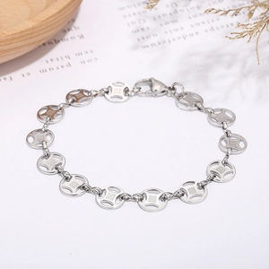 Detailed close-up of stainless steel bracelet featuring hollow cross pattern round links