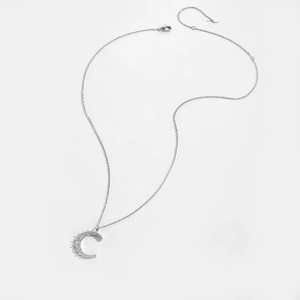 Macro shot of S925 sterling silver crescent moon pendant with micro-set zircons