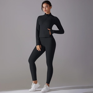 Detail of black high-stretch sports jacket with zipper and high-waist fitness leggings