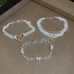 Minimalist silver-tone multi-layered bracelets with zircon hearts and bow details