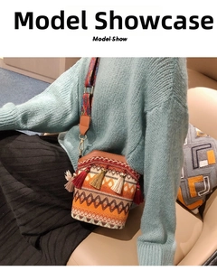 Bohemian woven crossbody bag with colorful geometric patterns and decorative tassels