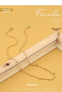 Detail of 18K gold plated station necklace with clear round-cut zircon stones