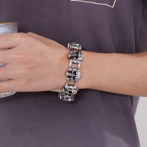 Detail of men's vintage stainless steel skull link bracelet worn on wrist