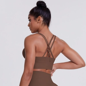 Detail of cross-back straps on brown sports bra showing fitness aesthetic and comfort