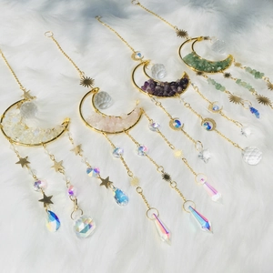 Detailed set of four gold moon crystal suncatchers with assorted natural gemstones