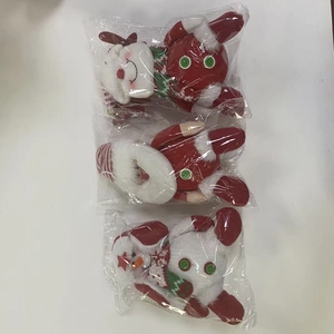 Close-up of Santa, snowman and reindeer plush ornaments in protective knit fabric