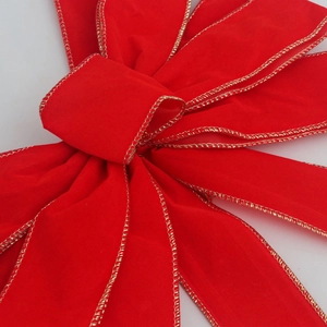 Red velvet Christmas bow with gold wire edges for festive holiday gift decoration